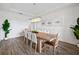 Elegant dining room with a long table, chandelier, and decorative artwork at 6318 Anise Dr, Sarasota, FL 34238