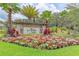 Beautiful entrance sign surrounded by colorful flowers and lush landscaping at 6318 Anise Dr, Sarasota, FL 34238