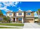Inviting two-story home featuring a well-maintained lawn, lush landscaping, and a two-car garage at 6318 Anise Dr, Sarasota, FL 34238