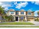 Inviting two-story home featuring a well-maintained lawn, lush landscaping, and a two-car garage at 6318 Anise Dr, Sarasota, FL 34238