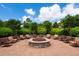 Beautiful community fire pit area with seating and lush landscaping to enjoy with neighbors at 6318 Anise Dr, Sarasota, FL 34238