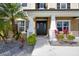 Close-up of the home's front entrance with a well-manicured garden, featuring a black front door at 6318 Anise Dr, Sarasota, FL 34238