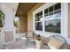 Cozy front porch with decorative chairs and natural light from large windows at 6318 Anise Dr, Sarasota, FL 34238