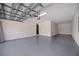 Spacious, clean garage with epoxy flooring and overhead lighting, ready for vehicles or storage at 6318 Anise Dr, Sarasota, FL 34238