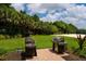 Outdoor grilling area with multiple stainless steel grills perfect for entertaining guests at 6318 Anise Dr, Sarasota, FL 34238