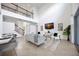 Bright living room with high ceilings, modern decor, and a view of the staircase at 6318 Anise Dr, Sarasota, FL 34238