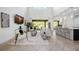 Open living room and bar, featuring tile floors and sliding glass doors to the pool at 6318 Anise Dr, Sarasota, FL 34238