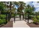 Fenced pet park for residents featuring secure gated entry, landscaping, and shade at 6318 Anise Dr, Sarasota, FL 34238