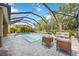 Inviting pool area featuring a screened-in enclosure, hot tub, and outdoor seating at 6318 Anise Dr, Sarasota, FL 34238