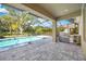 Outdoor kitchen and stainless steel grill next to the screened-in pool at 6318 Anise Dr, Sarasota, FL 34238