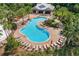 Aerial view of a resort-style community pool with lounge chairs and lush landscaping at 6318 Anise Dr, Sarasota, FL 34238