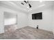 A bright, empty room with a ceiling fan and wood-look tile flooring at 6318 Anise Dr, Sarasota, FL 34238