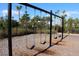 Community swing set surrounded by lush landscaping, offering a fun and safe play area at 6318 Anise Dr, Sarasota, FL 34238