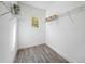 Empty walk-in closet features wood-look floors, wire shelving, and a window at 6318 Anise Dr, Sarasota, FL 34238