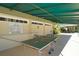 Outdoor table tennis and shaded seating near the pool at 7851 Allen Robertson Pl, Sarasota, FL 34240