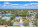 Luxury home community showcasing a lakefront property with surrounding houses at 8679 Woodbriar Dr, Sarasota, FL 34238