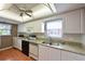 Well-equipped kitchen with granite countertops and white cabinets at 9411 Andover Cir, Bradenton, FL 34210