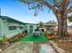 The backyard offers an outdoor dining area and mature tree, enhancing outdoor living and entertaining at 1000 Dartmouth Dr, Bradenton, FL 34207