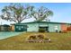 Charming home exterior with a well-maintained lawn and colorful landscaping, enhancing curb appeal at 1000 Dartmouth Dr, Bradenton, FL 34207