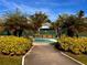 Landscaped park entrance with palm trees and a park bench at 12130 Dorado Dr, North Port, FL 34287