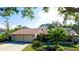 Two-car garage, mature landscaping, and a welcoming curb appeal at 1221 89Th Nw St, Bradenton, FL 34209