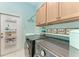 Laundry room with washer, dryer, and overhead cabinets at 12848 24Th Street E Cir, Parrish, FL 34219