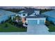 Two-story home with light paint, landscaping, and two-car garage at 14307 Skipping Stone Loop, Parrish, FL 34219