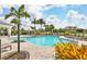 Community pool with lounge chairs and palm trees at 15619 Sacile Ln, Lakewood Ranch, FL 34211