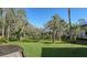 Spacious backyard adorned with mature trees and lush greenery, offering a tranquil outdoor setting at 1609 Palm View Rd, Sarasota, FL 34240
