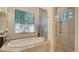Bright bathroom showcasing a modern tub and glass enclosed shower at 1609 Palm View Rd, Sarasota, FL 34240