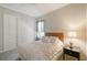 Cozy bedroom with a plush bed, side table, and door to living area at 1609 Palm View Rd, Sarasota, FL 34240