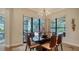 Dining room with a dark wood table, seating for six, and a backyard view at 1609 Palm View Rd, Sarasota, FL 34240