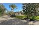 Well-maintained home with paver driveway, solar panels, lush lawn and mature trees at 1609 Palm View Rd, Sarasota, FL 34240
