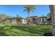 Charming home showcasing the landscaped front yard with palm tree and decorative stone and stucco exterior at 1609 Palm View Rd, Sarasota, FL 34240