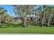 Spacious home with lush front lawn and mature palm trees offering privacy and curb appeal at 1609 Palm View Rd, Sarasota, FL 34240