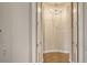 Hallway with neutral walls, chandelier, and decorative tile flooring at 1609 Palm View Rd, Sarasota, FL 34240