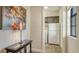 Hallway view to a laundry area with a washer, dryer, and cabinetry at 1609 Palm View Rd, Sarasota, FL 34240