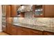 Gourmet kitchen featuring granite countertops, tile backsplash, and stainless steel appliances at 1609 Palm View Rd, Sarasota, FL 34240