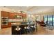 Modern kitchen with an island, granite countertops, stainless steel appliances, and a dining table at 1609 Palm View Rd, Sarasota, FL 34240