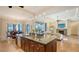 Island kitchen area with stone countertops open to the living room and dining room at 1609 Palm View Rd, Sarasota, FL 34240