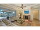 Inviting living room with fireplace, comfortable seating, and views of the screened-in pool area at 1609 Palm View Rd, Sarasota, FL 34240