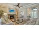 Spacious living room with a stone fireplace, TV, and a view into the entry area at 1609 Palm View Rd, Sarasota, FL 34240