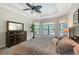 Relaxing main bedroom boasts tray ceiling, large windows, and backyard views at 1609 Palm View Rd, Sarasota, FL 34240