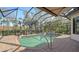 Beautiful pool within a screened enclosure, includes lush landscaping and comfortable lounge chairs at 1609 Palm View Rd, Sarasota, FL 34240