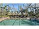 Private backyard pool with screened enclosure offers a tranquil view at 1609 Palm View Rd, Sarasota, FL 34240