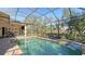 Inviting pool area with screened enclosure, lounge seating, and serene backyard scenery at 1609 Palm View Rd, Sarasota, FL 34240