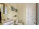 Cozy powder room with decorative mirror and floral wall art at 1609 Palm View Rd, Sarasota, FL 34240