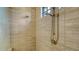 Neutral tiled walk-in shower showcasing both a rainfall and handheld shower head, plus a window for natural light at 1609 Palm View Rd, Sarasota, FL 34240
