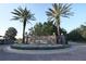 Elegant stone community entrance sign surrounded by meticulously maintained landscaping and palm trees at 16907 Verona Place, Lakewood Ranch, FL 34202