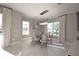 Elegant dining room features a modern chandelier, neutral tones, and an abundance of natural light at 16907 Verona Place, Lakewood Ranch, FL 34202